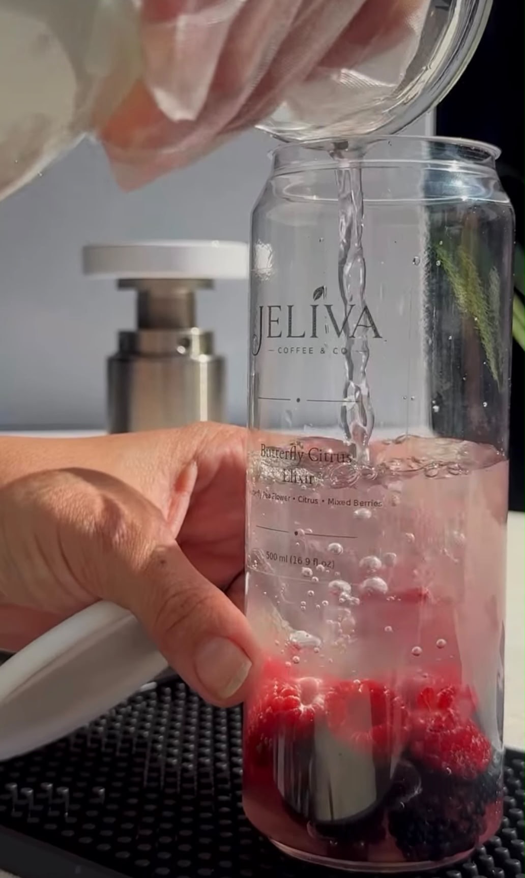 Butterfly Citrus Elixir being prepared with berries