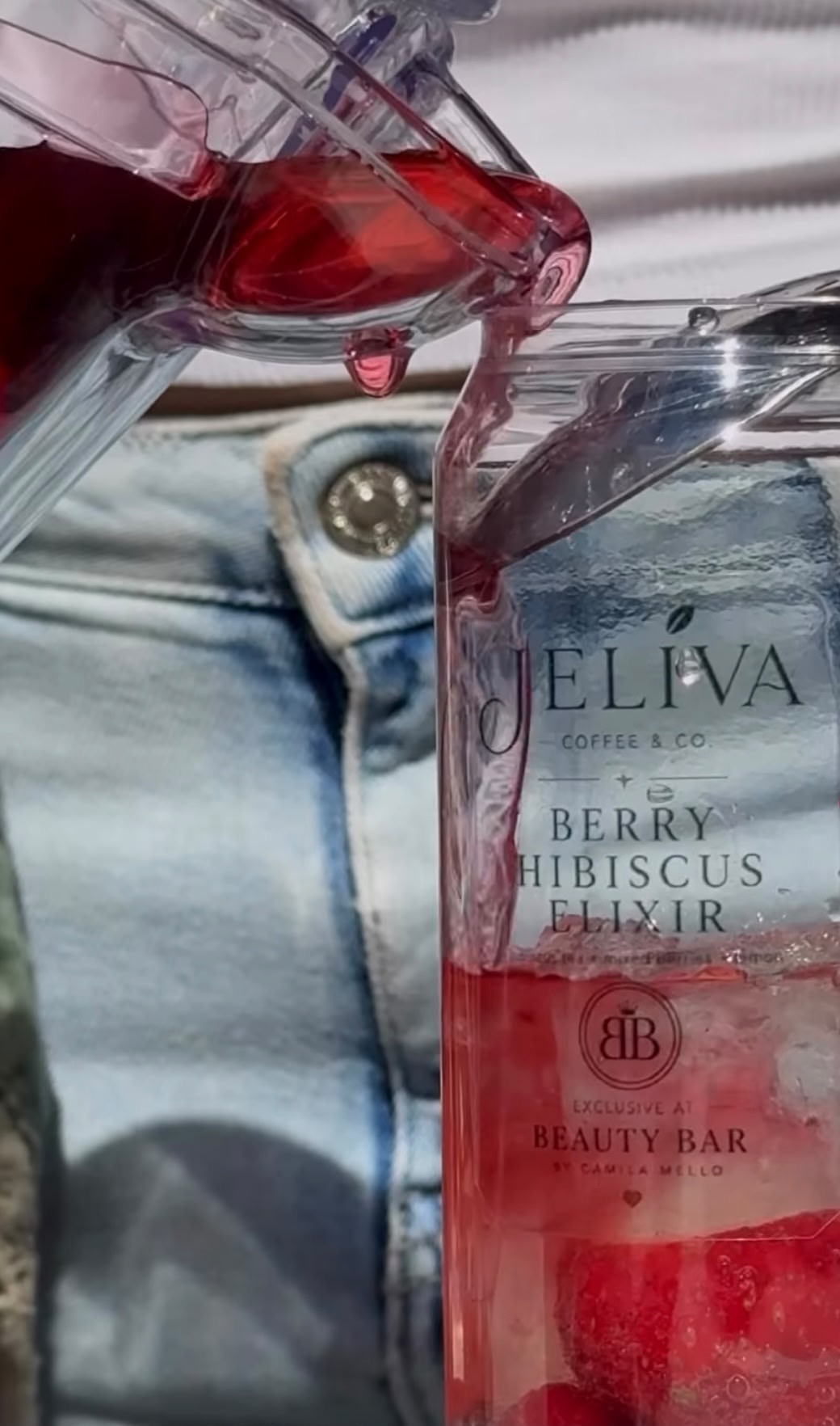 Berry Hibiscus Elixir being poured into a clear can